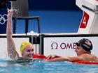 Ariarne Titmus (left) reacts with Katie Ledecky after her win.