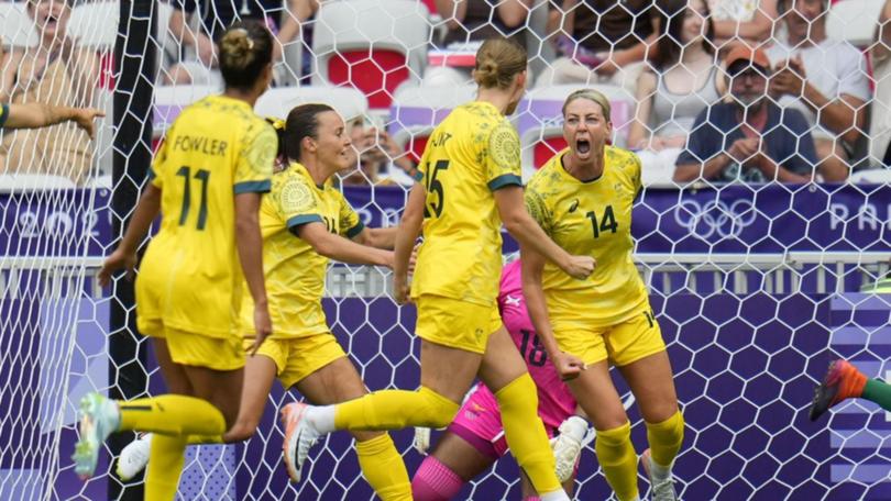 Scorer Alanna Kennedy (14) hails the Matildas' opener in their amazing 6-5 win over Zambia.