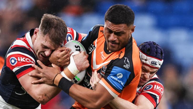 Giant prop Stefano Utoikamanu (c) has told Wests Tigers he's leaving after this NRL season. (Mark Evans/AAP PHOTOS)