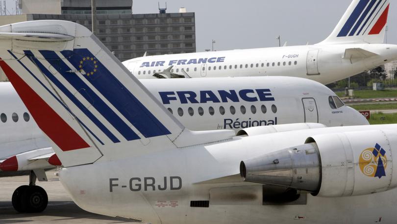 ** FILE ** Air France planes are parked at Roissiy-Charles de Gaulle airport, north of Paris in this April 28, 2006 file picture. Air France-KLM, the world's largest airline by sales, posted a 30 percent drop in net profit for the fiscal fourth quarter, but said underlying earnings were stable despite soaring oil prices, Thursday, May 18, 2006. (AP Photo/Christophe Ena)