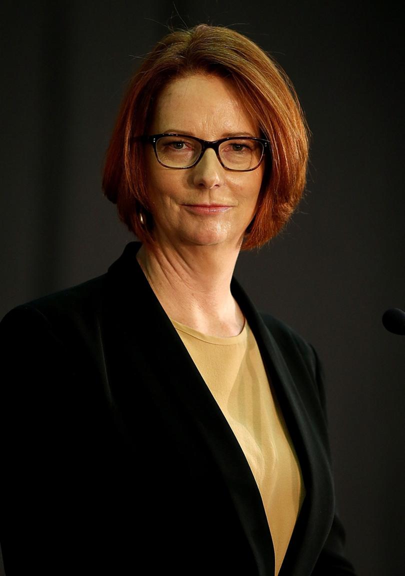 ADELAIDE, AUSTRALIA - FEBRUARY 20:  Australian Prime Minister Julia Gillard stands at the lectern inside the community hall at The Hub Recreation Centre on February 20, 2013 in Adelaide, Australia. Prime Minister Gillard today denied that the decision by the Greens to end their alliance with the ALP will have any consequences for the government for the remainder of the year.  (Photo by Morne de Klerk/Getty Images)