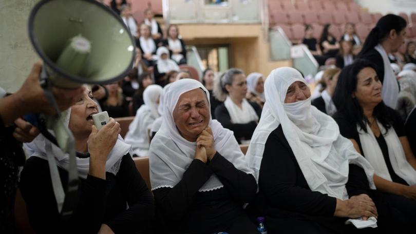 Members of the Druze minority attend a memorial ceremony for the children and teens, killed in a rocket strike in Majdal Shams.