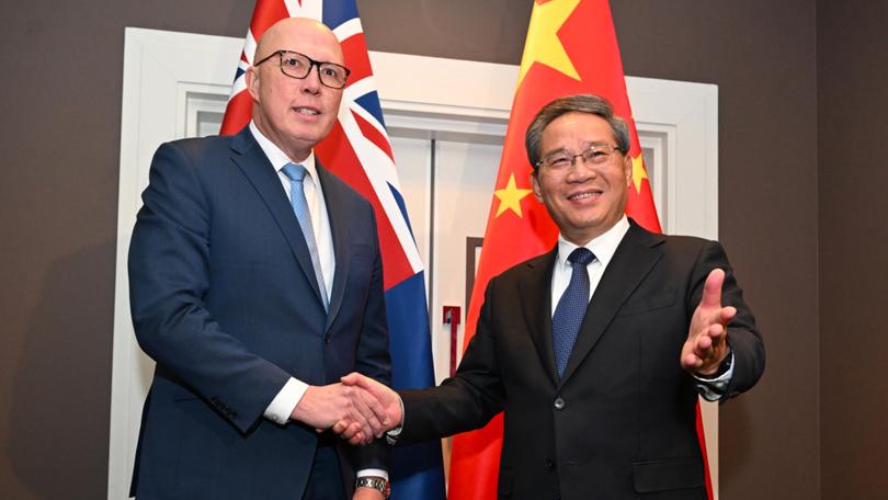 Chinese Premier Li Qiang shakes hands with Australian Opposition Leader Peter Dutton in June.