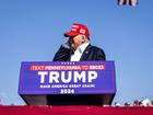 Former President Donald Trump reaches to touch his ear as he speaks at a campaign rally in Butler, Pa., on Saturday.