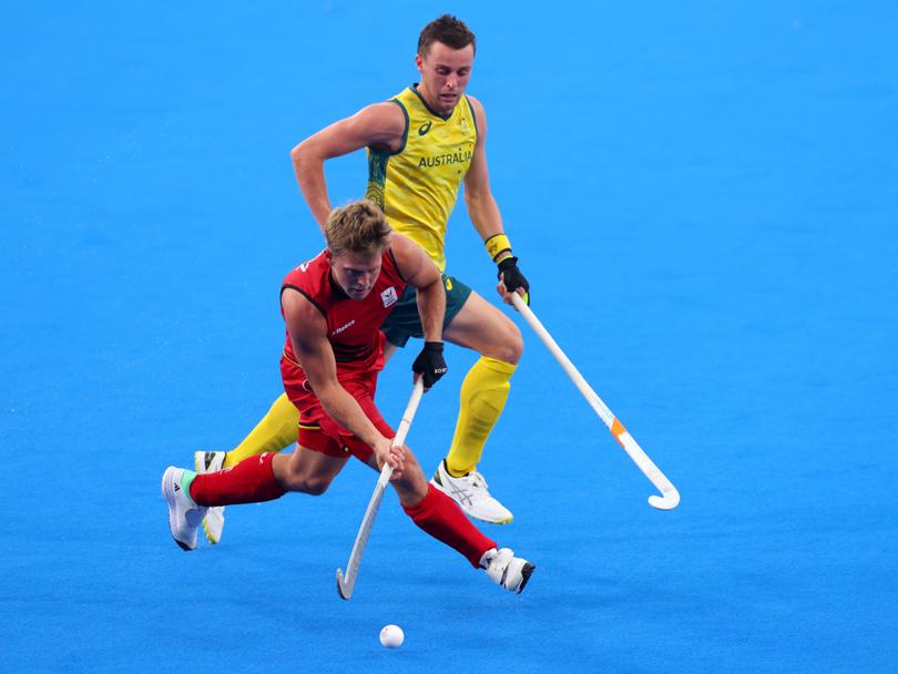 Victor Wegnez of Team Belgium runs with the ball whilst under pressure from Ky Willott of Team Australia.