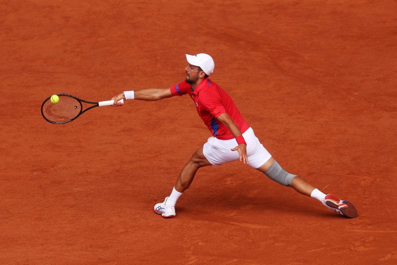 PARIS, FRANCE - JULY 31: Novak Djokovic of Team Serbia plays a forehand against Dominik Koepfer of Team Germany during the Men's Singles Third Round match on day five of the Olympic Games Paris 2024 at Roland Garros on July 31, 2024 in Paris, France. (Photo by Julian Finney/Getty Images)