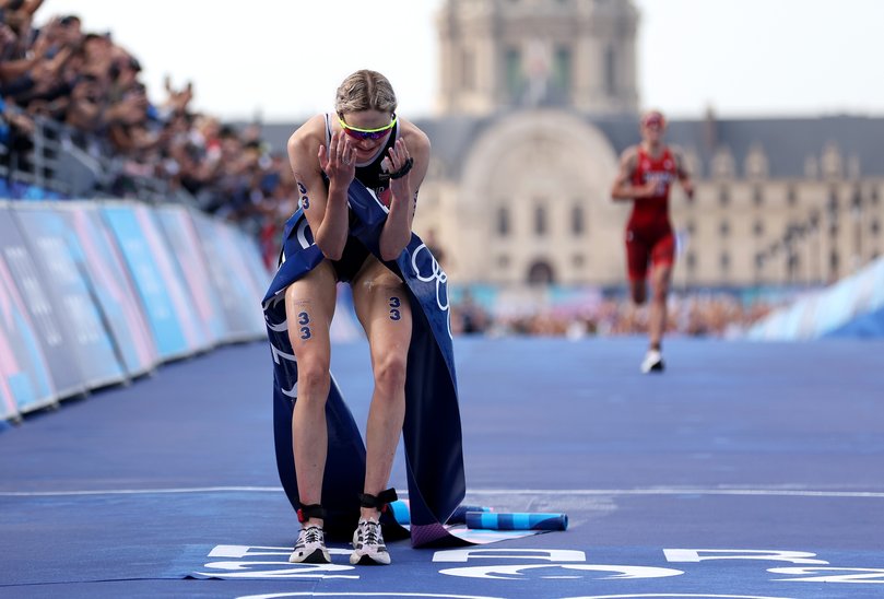 PARIS, FRANCE - JULY 31: Cassandre Beaugrand of Team France celebrates winning the gold medal after competing in Women's Individual Triathlon on day five of the Olympic Games Paris 2024 at Pont Alexandre III on July 31, 2024 in Paris, France. (Photo by Michael Steele/Getty Images)