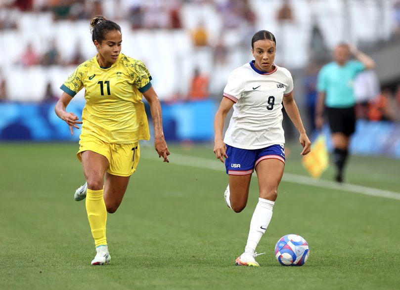 MARSEILLE, FRANCE - JULY 31: Mallory Swanson #9 of Team United States runs with the ball whilst under pressure from Mary Fowler #11 of Team Australia during the Women's group B match between Australia and United States during the Olympic Games Paris 2024 at Stade de Marseille on July 31, 2024 in Marseille, France. (Photo by Alex Livesey/Getty Images)