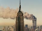 The twin towers of the World Trade Center burn behind the Empire State Building in New York during the September 11 attacks.