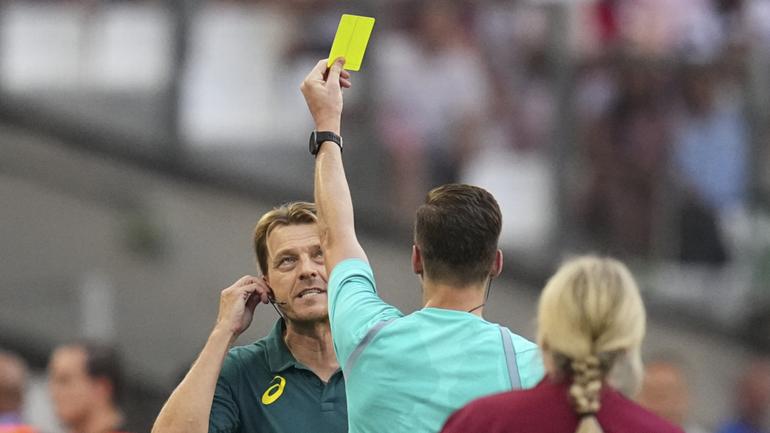 Australia coach Tony Gustvasson  is shown a yellow card by French referee Francois Letexier during the loss to the USA  overnight.