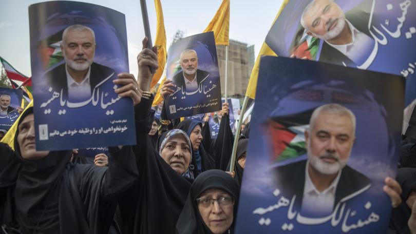 Hundreds of Iranians take part in a protest against the killing of Ismail Haniyeh.