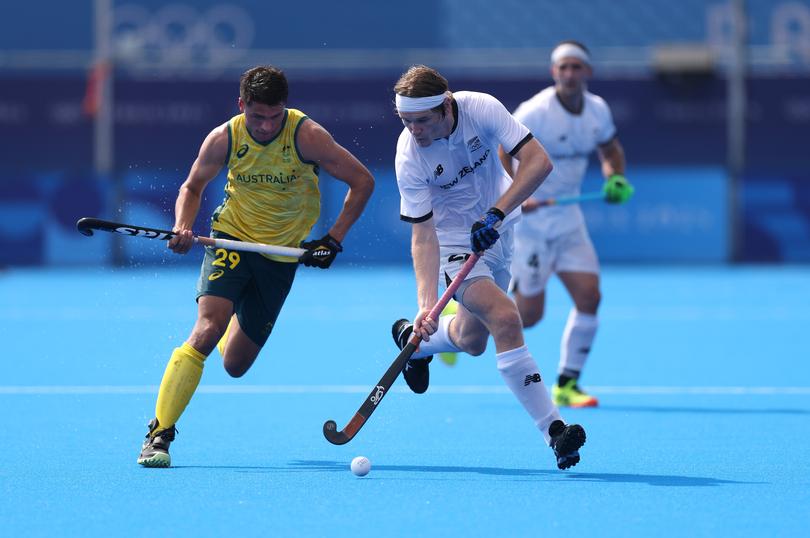 PARIS, FRANCE - AUGUST 01: Blair Tarrant of Team New Zealand runs with the ball whilst under pressure from Tim Brand of Team Australia during the Men's Pool B match New Zealand and Australia on day six of the Olympic Games Paris 2024 at Stade Yves Du Manoir on August 01, 2024 in Paris, France. (Photo by Alex Pantling/Getty Images)