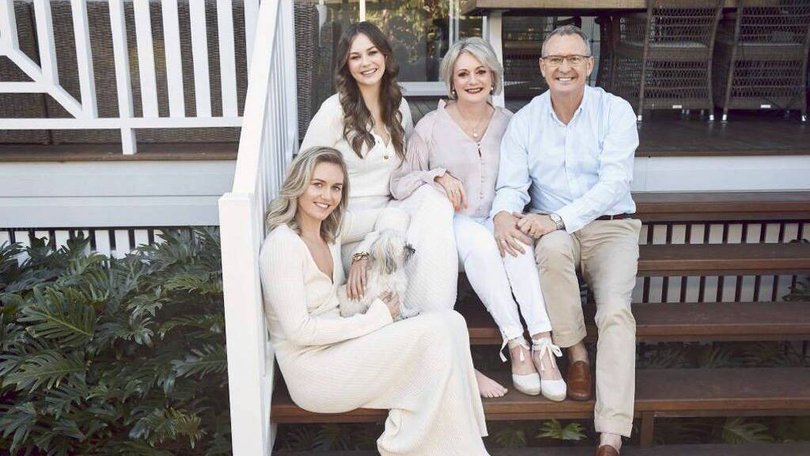 Ariarne, her younger sister Mia and parents Steve and Robyn at the family home they are now selling.