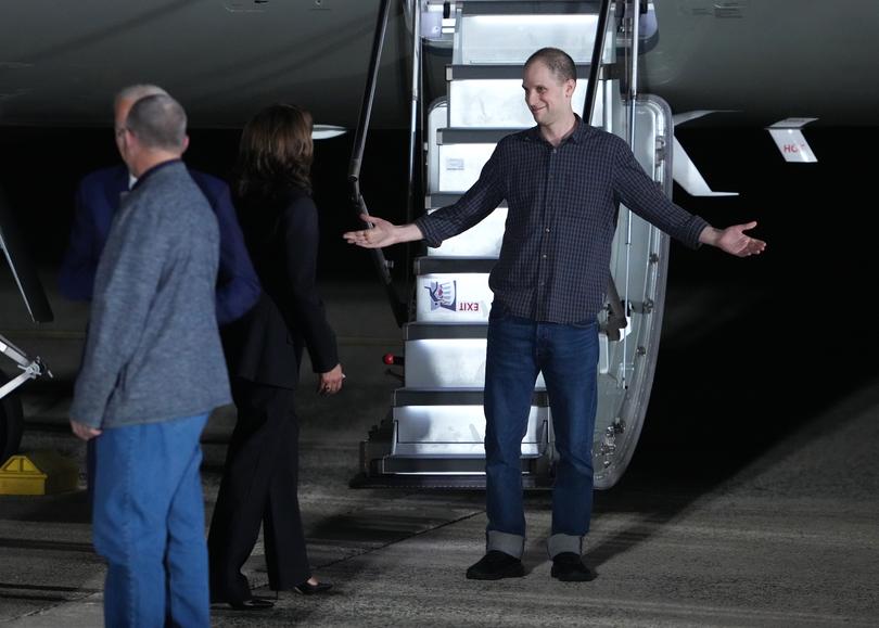 Gershkovich greets Vice President Harris as he walks off the plane.