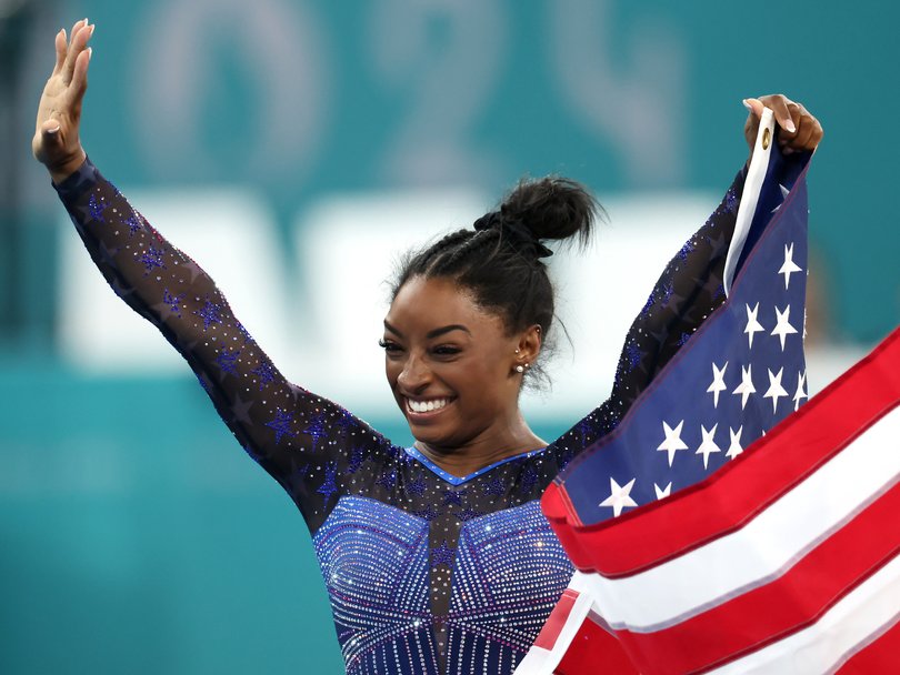 Simone Biles celebrates after winning gold in the all-around finals at the Paris Olympics.