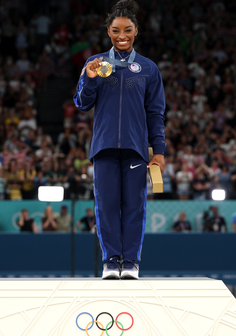 Simone Biles celebrates after winning gold in the all-around finals at the Paris Olympics.