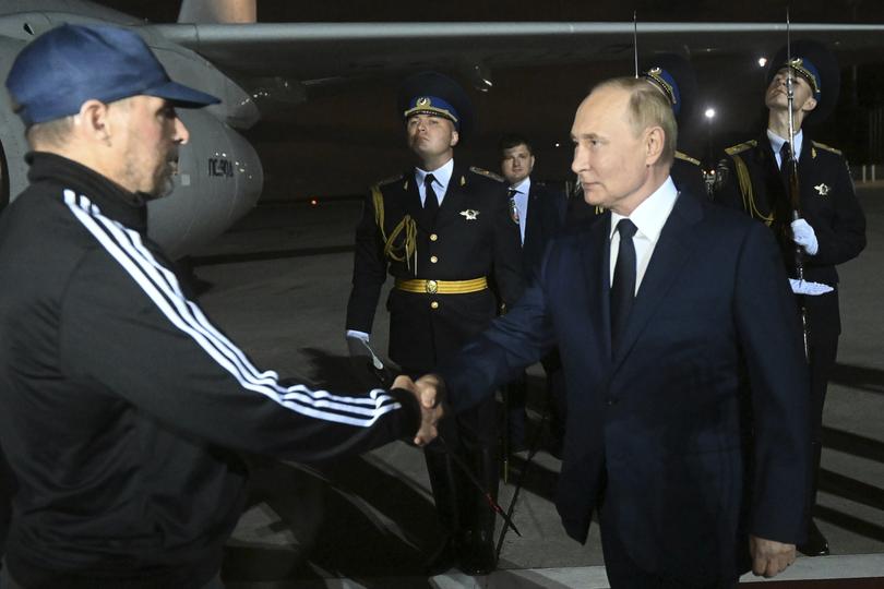 Russian President Vladimir Putin greets Vadim Krasikov upon arrival of freed Russian prisoners at Vnukovo government airport outside Moscow.