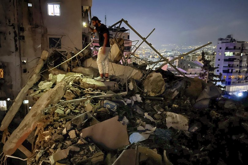 A man inspects a destroyed building that was hit by an Israeli airstrike in the southern suburbs of Beirut, Lebanon, Tuesday, July 30, 2024. An Israeli airstrike hit Hezbollah's stronghold south of Beirut Tuesday evening causing damage, a Hezbollah official and the group's TV station said. (AP Photo/Hussein Malla)