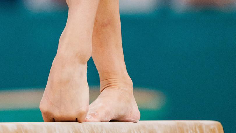 The American Sunisa Lee, a gymnast whose joints are under constant strain, practices on the beam at the Olympics in Paris, July 28, 2024. With years of fractures, surgeries, hardware and pain, Olympians can list their injuries as readily as their achievements. (Gabriela Bhaskar/The New York Times)