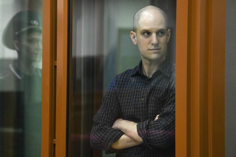 FILE - Wall Street Journal reporter Evan Gershkovich stands in a glass defendant's booth in a courtroom in Yekaterinburg, Russia, on June 26, 2024.