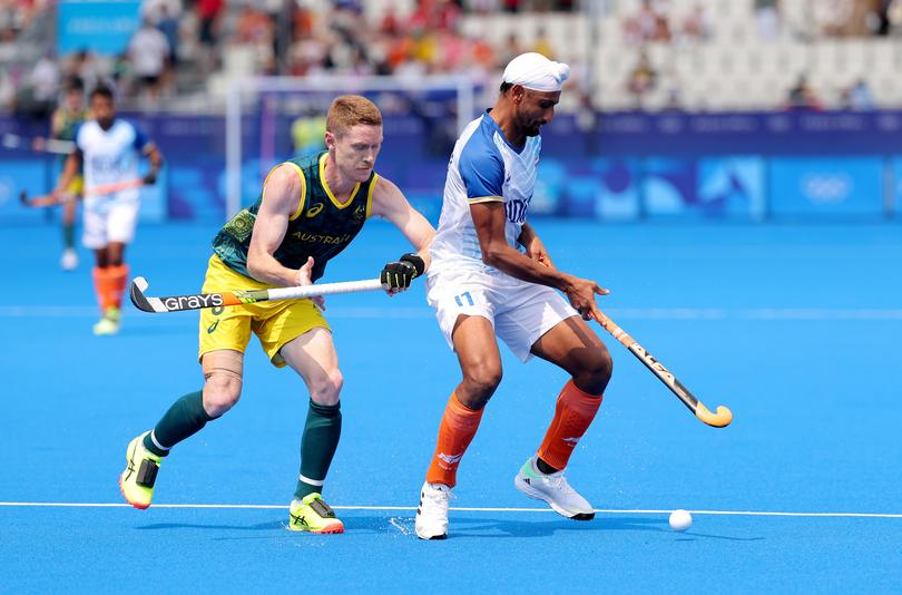 PARIS, FRANCE - AUGUST 02: Mandeep Singh of Team India runs with the ball whilst under pressure from Matthew Dawson of Team Australia during the Men's Pool B match between Australia and India on day seven of the Olympic Games Paris 2024 at Stade Yves Du Manoir on August 02, 2024 in Paris, France. (Photo by Buda Mendes/Getty Images)