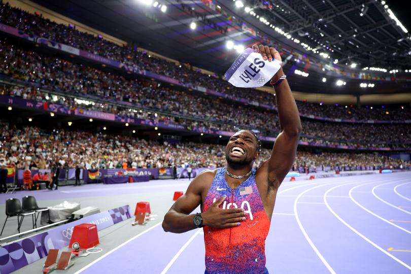 Lyles salutes the crowd.