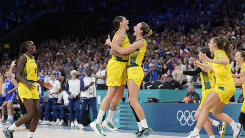 Cayla George and Alanna Smith embrace after the Opals won by enough to seal second in their pool.