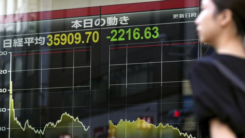 Japan's benchmark Nikkei 225 stock index has plunged, extending sell-offs that began last week. (AP PHOTO)