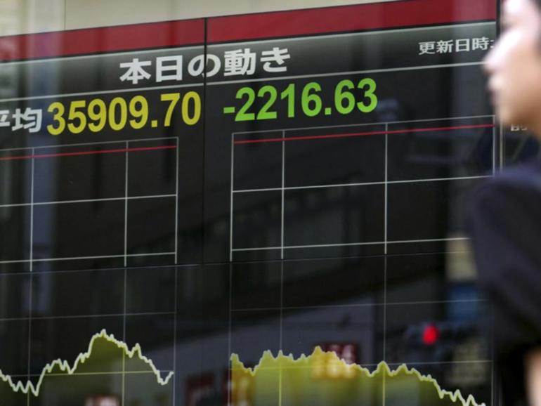 Japan's benchmark Nikkei 225 stock index has plunged, extending sell-offs that began last week. (AP PHOTO)