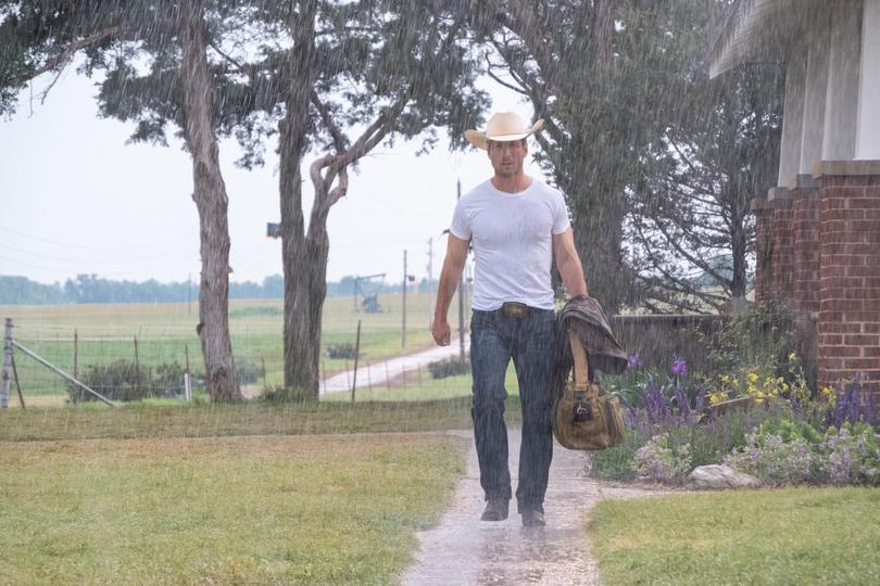 Glen Powell in a white tee in Twisters.