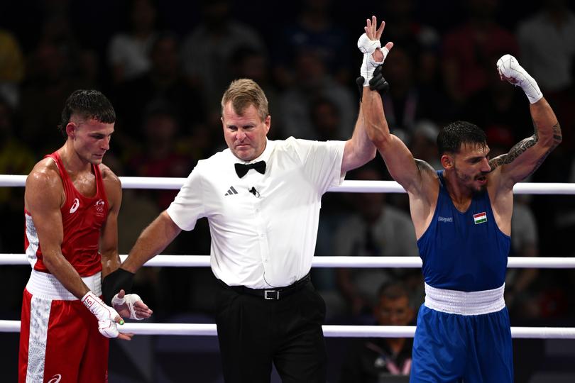 Harry Garside of Australia (left) reacts after being defeated by Richard Kovacs of Hungary during the Men’s 60.5 kg preliminaries at North Paris Arena as part of the 2024 Paris Summer Olympic Games in Paris, France, Monday, July 29, 2024. (AAP Image/Dan Himbrechts) NO ARCHIVING