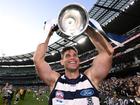 Tom Hawkins celebrates with the premiership trophy in 2022, the third of his three titles. (Joel Carrett/AAP PHOTOS)