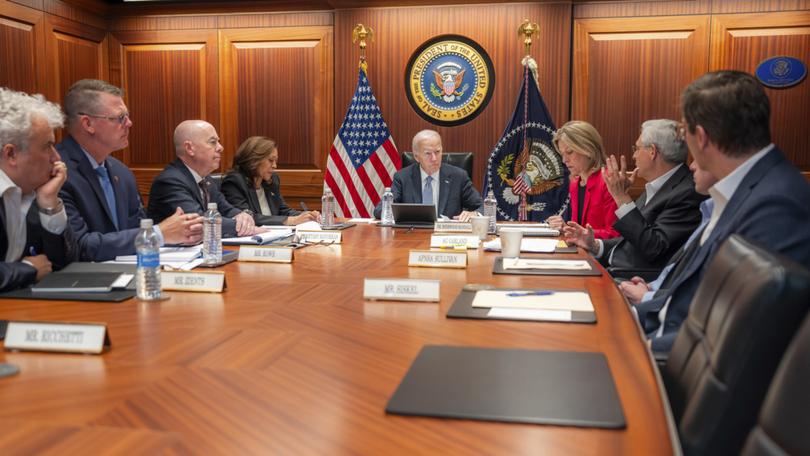 In this image provided by the White House, President Joe Biden, center, and Vice President Kamala Harris, fourth from left, are briefed by national security advisers and members of law enforcement agencies on the apparent assassination attempt Saturday on former President Donald Trump in Butler, Pa., in the White House Situation Room in Washington, Sunday, July 14, 2024. Pictured from left are White House chief of staff Jeff Zients, Secret Service deputy director Ronald L. Rowe, Jr., Homeland Security Secretary Alejandro Mayorkas, Harris, Biden, Homeland Security adviser Elizabeth Sherwood-Randall, Attorney General Merrick Garland, White House national security adviser Jake Sullivan and White House counsel Ed Siskel. Some papers on the desk have been blurred by the source for national security reasons. (Adam Schultz/The White House via AP)