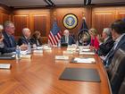 In this image provided by the White House, President Joe Biden, center, and Vice President Kamala Harris, fourth from left, are briefed by national security advisers and members of law enforcement agencies on the apparent assassination attempt Saturday on former President Donald Trump in Butler, Pa., in the White House Situation Room in Washington, Sunday, July 14, 2024. Pictured from left are White House chief of staff Jeff Zients, Secret Service deputy director Ronald L. Rowe, Jr., Homeland Security Secretary Alejandro Mayorkas, Harris, Biden, Homeland Security adviser Elizabeth Sherwood-Randall, Attorney General Merrick Garland, White House national security adviser Jake Sullivan and White House counsel Ed Siskel. Some papers on the desk have been blurred by the source for national security reasons. (Adam Schultz/The White House via AP)