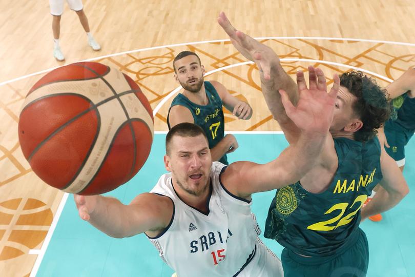 PARIS, FRANCE - AUGUST 06: Nikola Jokic #15 of Team Serbia takes a shot against Will Magnay #22 of Team Australia during the Men's Quarterfinal match between Team Australia and Team Serbia on day eleven of the Olympic Games Paris 2024 at Bercy Arena on August 06, 2024 in Paris, France. (Photo by Jamie Squire/Getty Images)