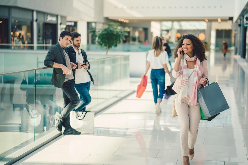 Young woman talking on phone in the shopping mall martin-dm