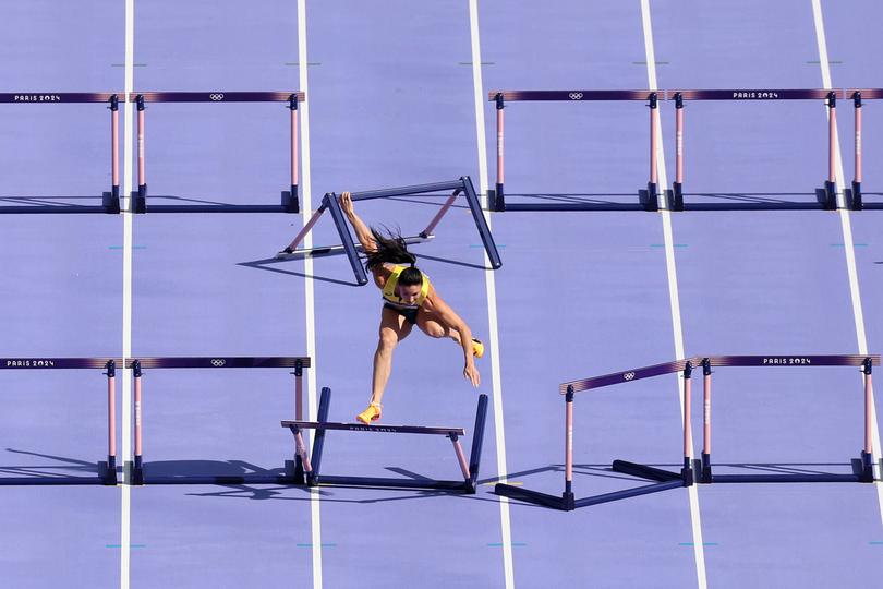 PARIS, FRANCE - AUGUST 07: (EDITORS NOTE: Image was captured using a robotic camera positioned above the field of play.) Michelle Jenneke of Team Australia knocks over a hurdle during the Women's 100m Hurdles Round 1 on day twelve of the Olympic Games Paris 2024 at Stade de France on August 07, 2024 in Paris, France. (Photo by Patrick Smith/Getty Images)