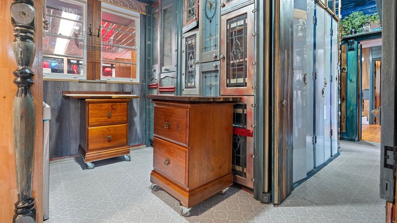 The kitchen cupboards are built from repurposed ornate glass doors.