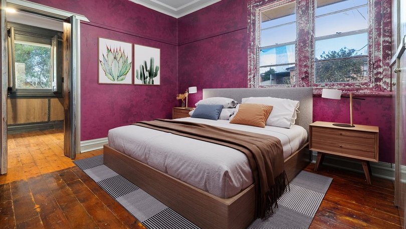 Purple adorns the walls in the master bedroom.