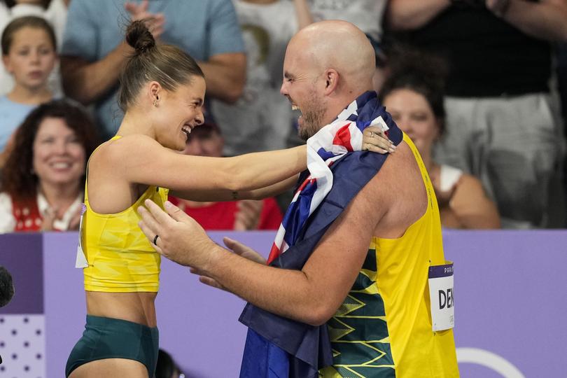 Nina Kennedy, of Australia, celebrates after winning the women's pole vault final with Matthew Denny, of Australia.