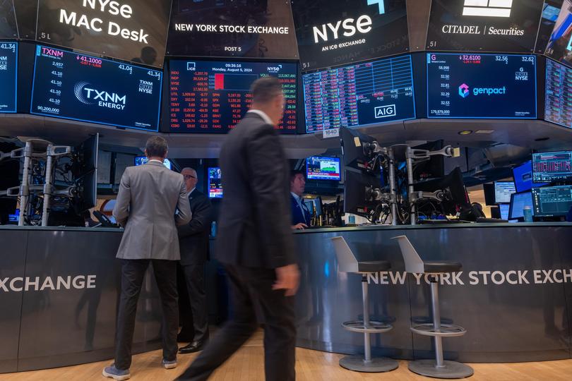 Traders work on the floor of the New York Stock Exchange on August 5.