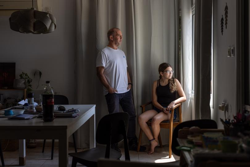 From left: Erez Bergman and his daughter Ella Bergman, Kibbutz members who evacuated and decided to return to their house, in Snir, Israel, on July 16, 2024. 