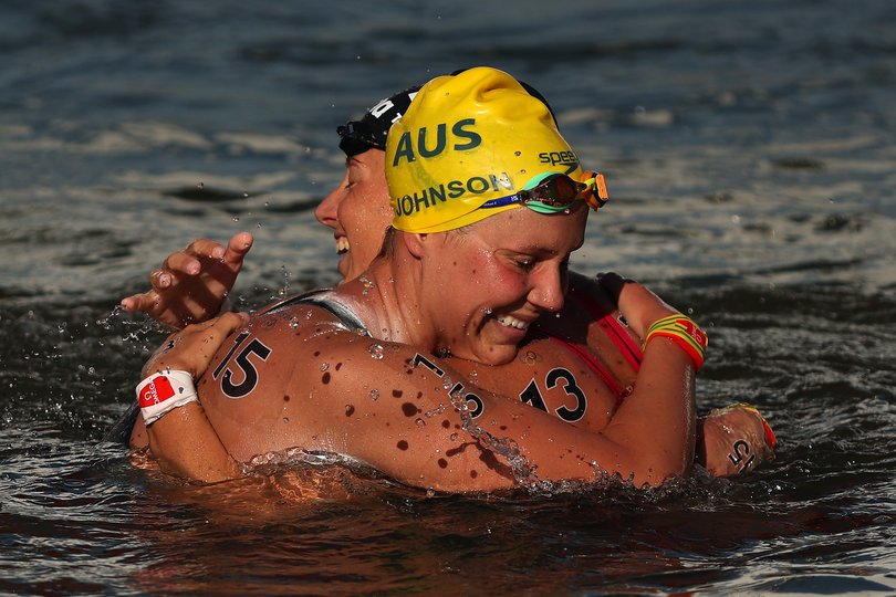 PARIS, FRANCE - AUGUST 08: Moesha Johnson of Team Australia and Ginevra Taddeucci of Team Italy celebrate after winning silver and bronze in the Marathon Swimming Women's 10k on day thirteen of the Olympic Games Paris 2024 at Pont Alexandre III on August 08, 2024 in Paris, France. (Photo by Sarah Stier/Getty Images)