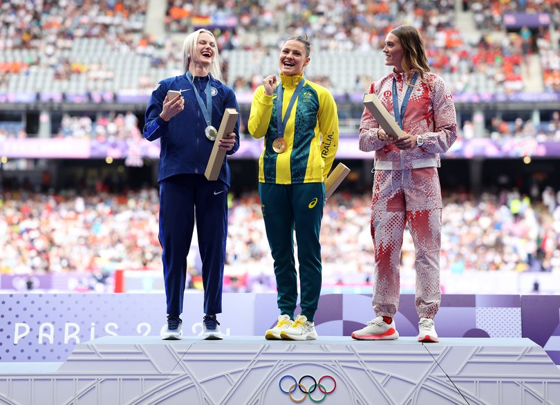 PARIS, FRANCE - AUGUST 08: Gold medalist Nina Kennedy of Team Australia (C), Silver medalist Katie Moon of Team United States and Bronze medalist Alysha Newman of Team Canada celebrate on the podium during the Women's 3000m Steeplechase medal ceremony on day thirteen of the Olympic Games Paris 2024 at Stade de France on August 08, 2024 in Paris, France. (Photo by Elsa/Getty Images)