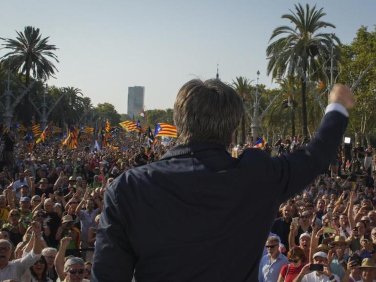 Catalan independence leader Carles Puigdemont addressed a Barcelona rally before disappearing.