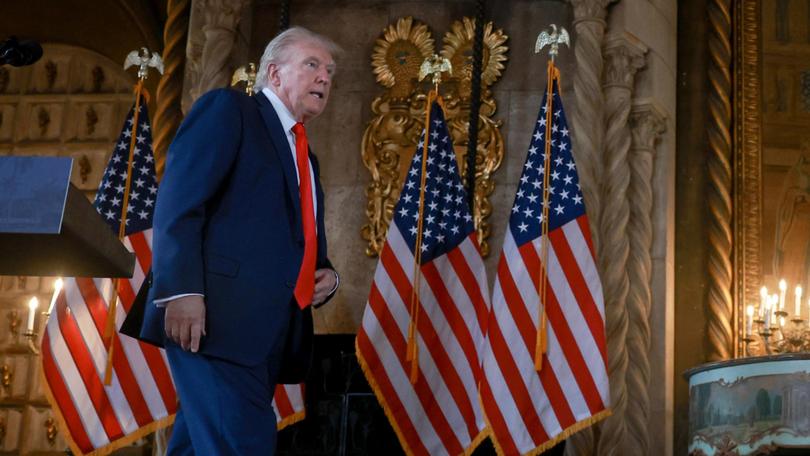 Donald Trump leaves after holding a press conference at his Mar-a-Lago estate.