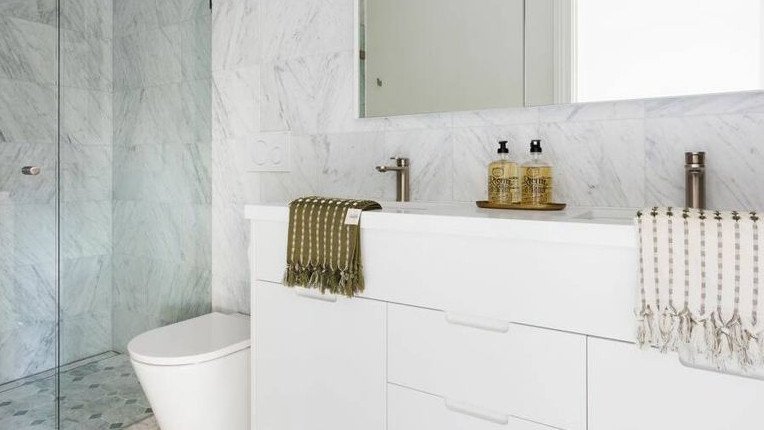 Marble flows seamlessly throughout the home including the luxurious bathroom.