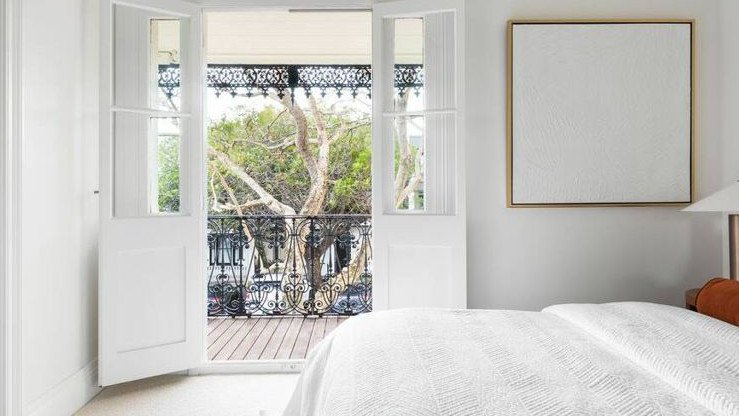 The master suite opens onto a sunny balcony.