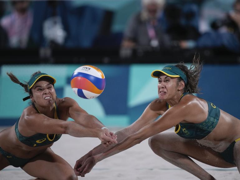 Australia's Mariafe Artacho del Solar, left, and Taliqua Clancy return a ball in the women's beach volleyball bronze medal match between Australia and Switzerland, at the 2024 Summer Olympics, Friday, Aug. 9, 2024, in Paris, France. (AP Photo/Louise Delmotte)