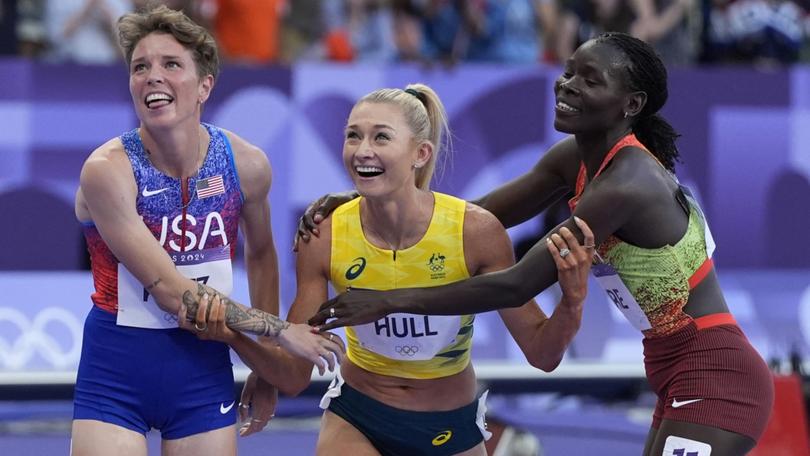 Jessica Hull, of Australia, is congratulated by Susan Lokayo Ejore, right, of Kenya, and Nikki Hiltz, of the United States, after her second place finish in the women's 1500-meter final at the 2024 Summer Olympics, Saturday, Aug. 10, 2024, in Saint-Denis, France. (AP Photo/Matthias Schrader)